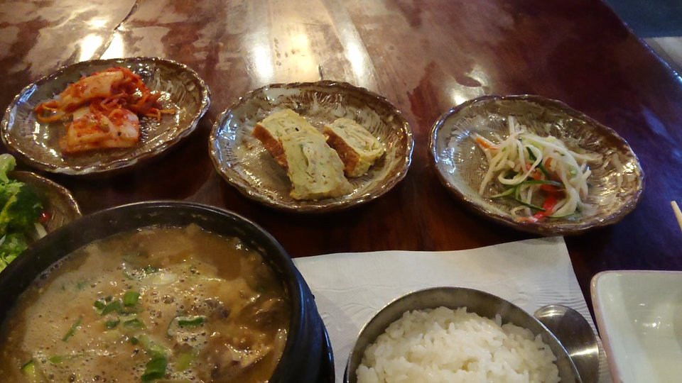 Korean restaurant interior with simple tables and chairs.